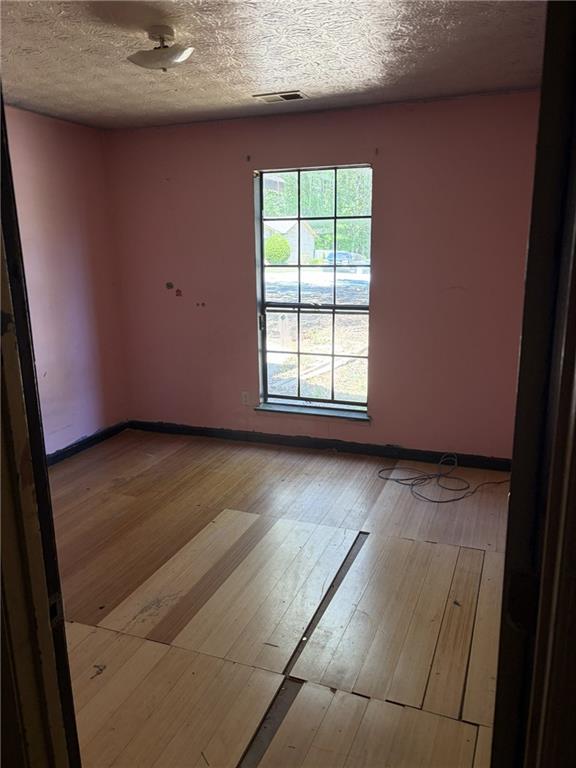 8521 Cedar Creek Ridge Riverdale, GA 30274 - Photo 7 of 9 an empty room with wooden floor and windows