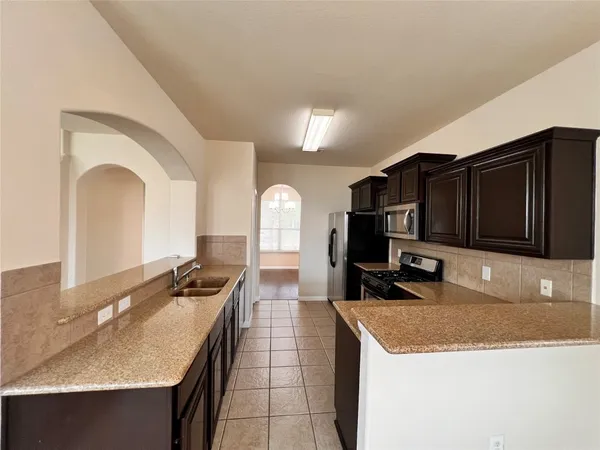 a kitchen with a sink and a refrigerator