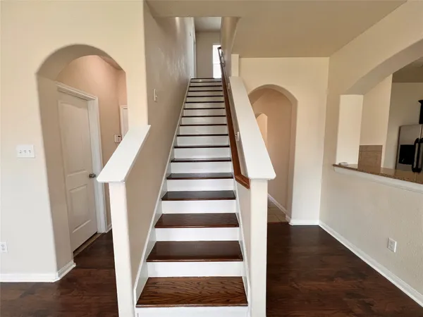 a view of entryway and hall with wooden floor