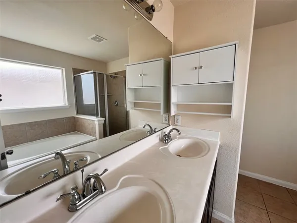 a bathroom with a tub sink and mirror