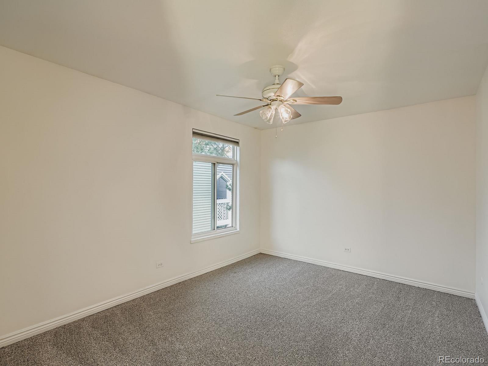 3420 South Locust Street, Unit D Denver, CO 80222 - Photo 11 of 16 an empty room with windows and fan