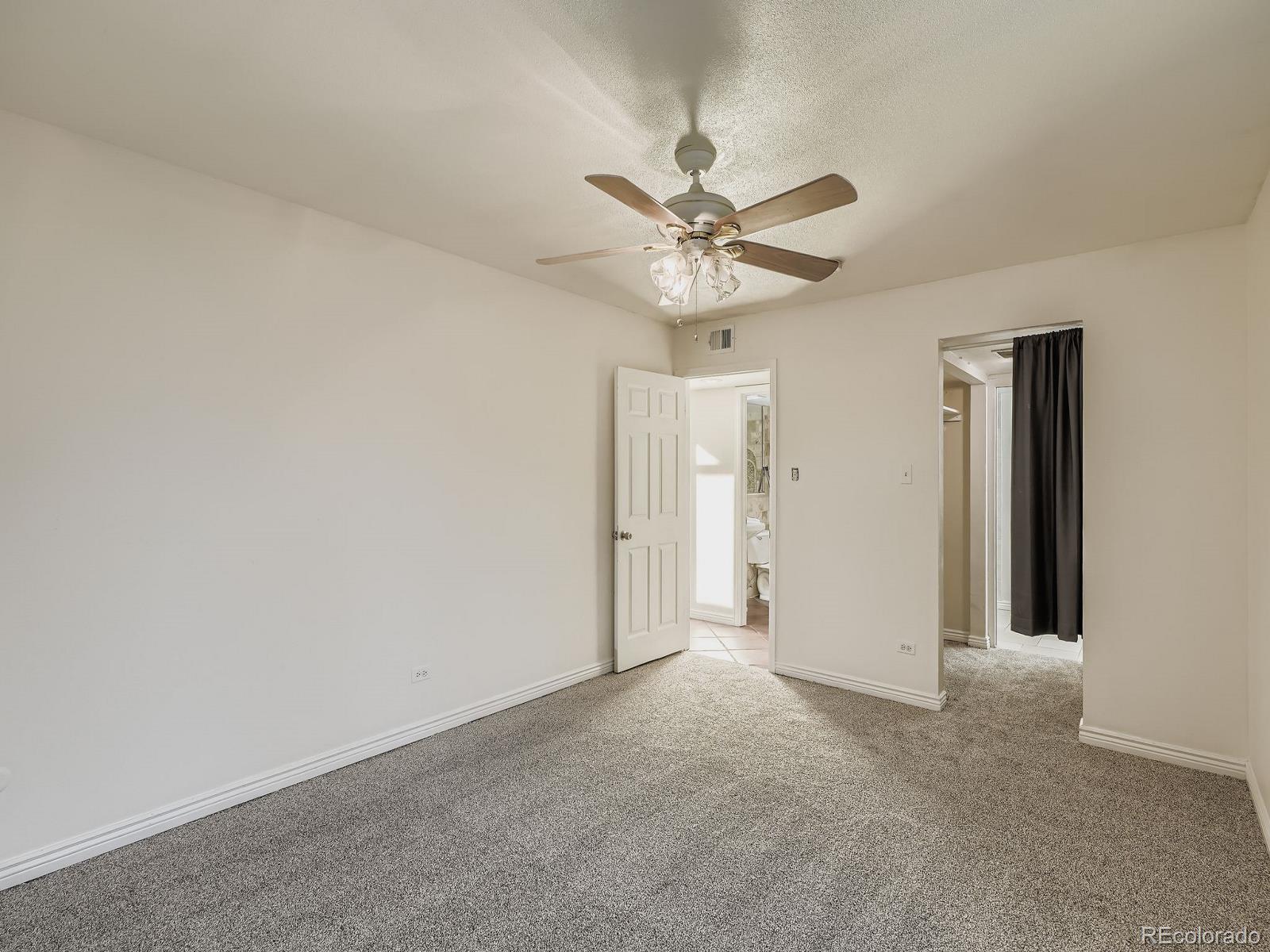 3420 South Locust Street, Unit D Denver, CO 80222 - Photo 10 of 16 a view of a big room with chandelier fan