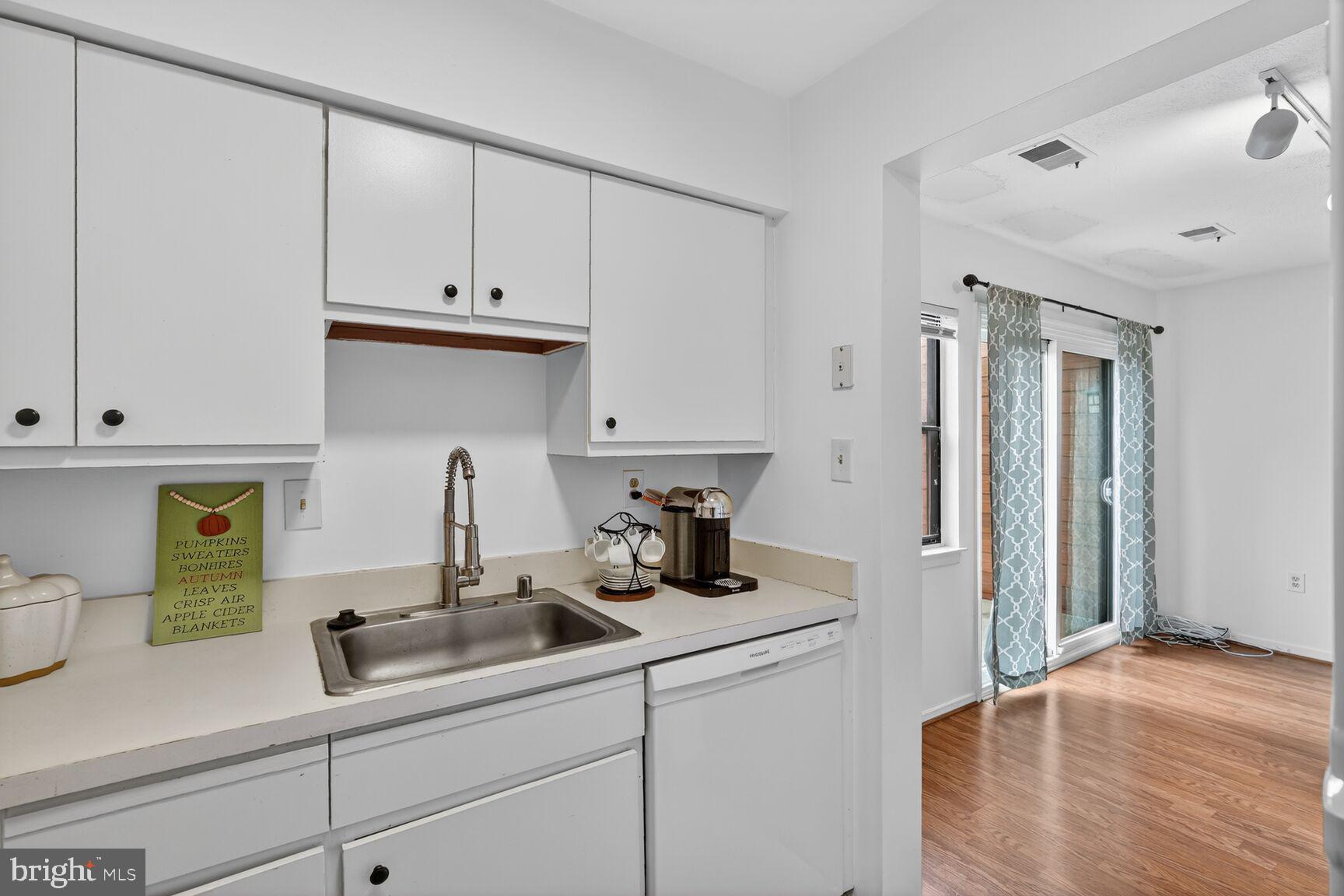 7505 Weather Worn Way, Unit E Columbia, MD 21046 - Photo 11 of 32 a kitchen with a sink and cabinets