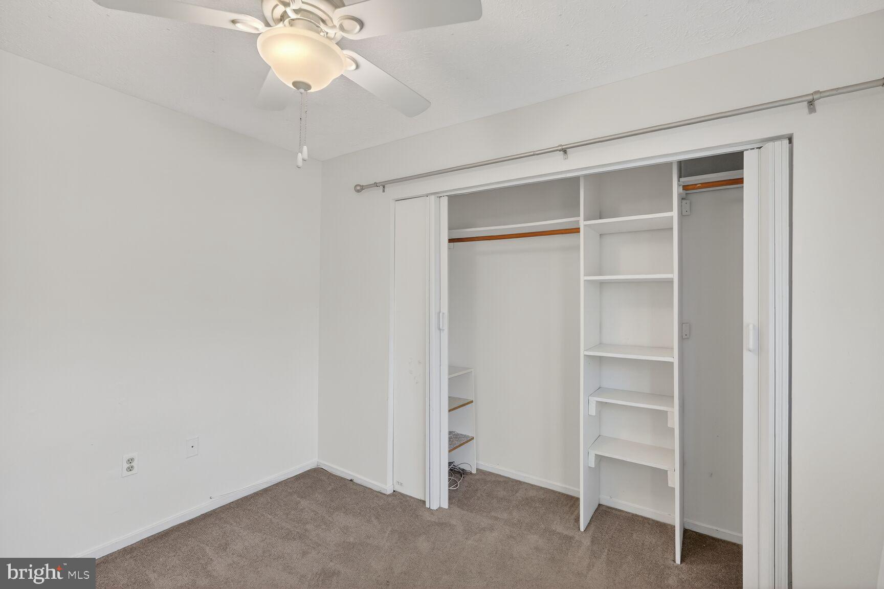 7505 Weather Worn Way, Unit E Columbia, MD 21046 - Photo 15 of 32 a view of an empty room with a ceiling fan