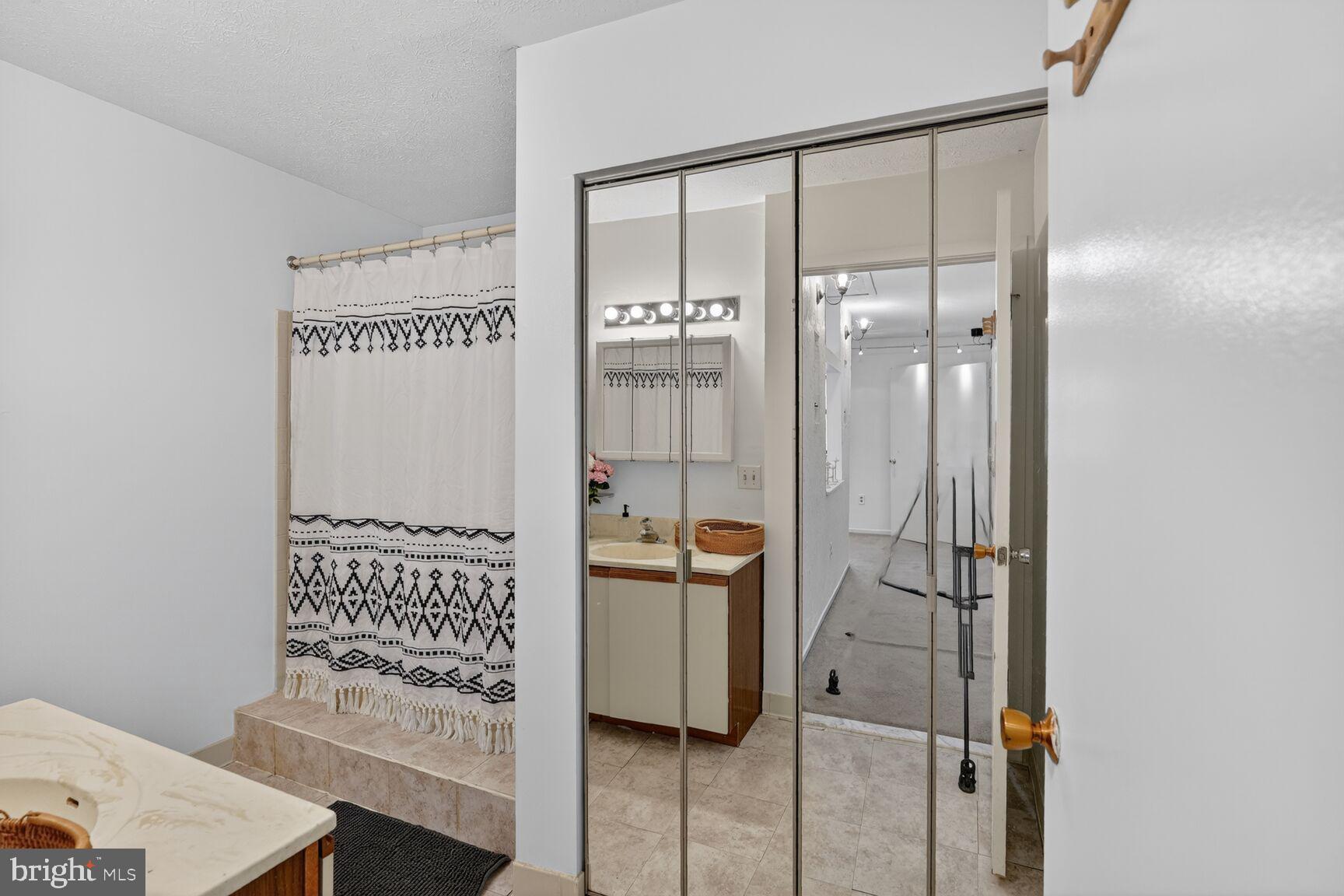 7505 Weather Worn Way, Unit E Columbia, MD 21046 - Photo 18 of 32 a bathroom with a shower and a sink