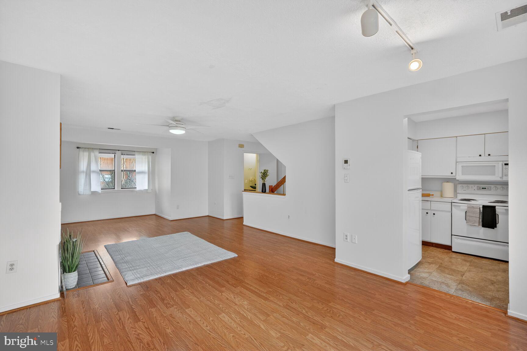 7505 Weather Worn Way, Unit E Columbia, MD 21046 - Photo 9 of 32 a view of kitchen and hall with wooden floor