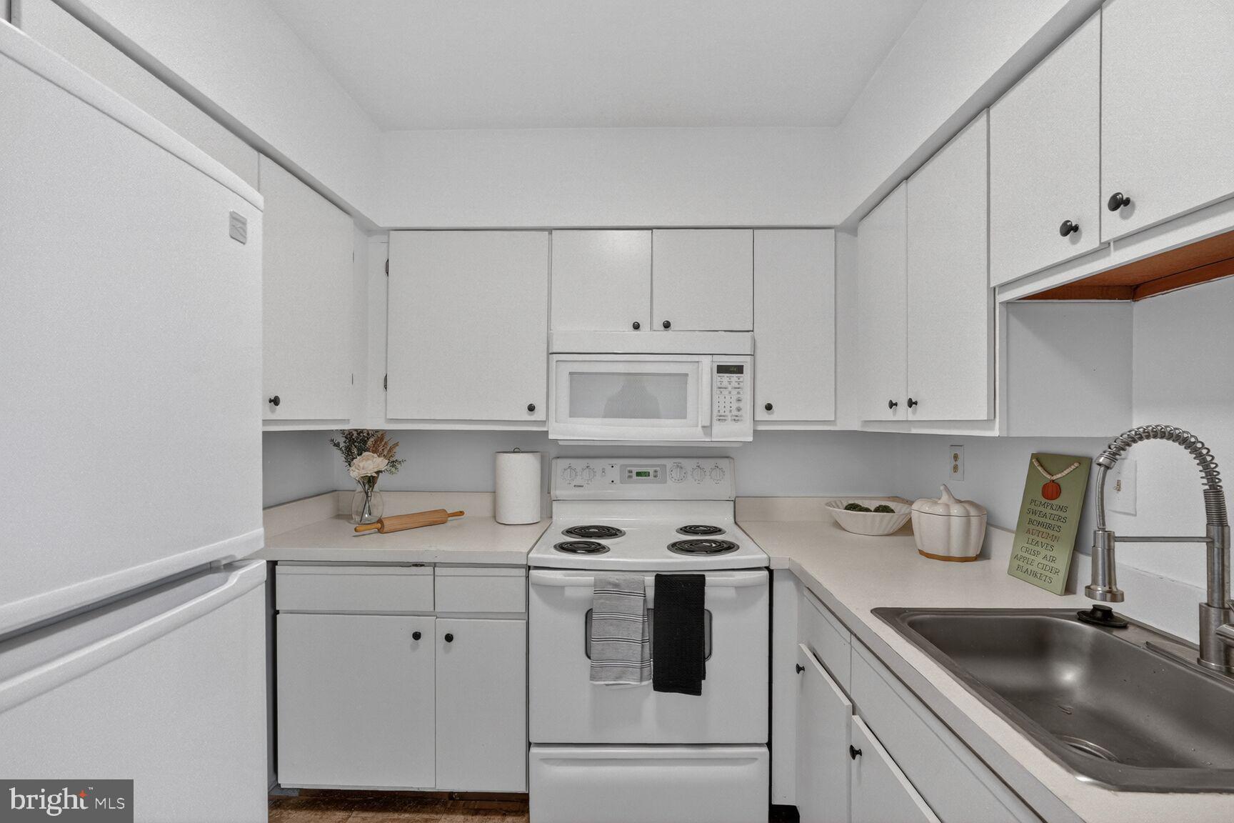 7505 Weather Worn Way, Unit E Columbia, MD 21046 - Photo 10 of 32 a kitchen with cabinets appliances a sink and a cabinets