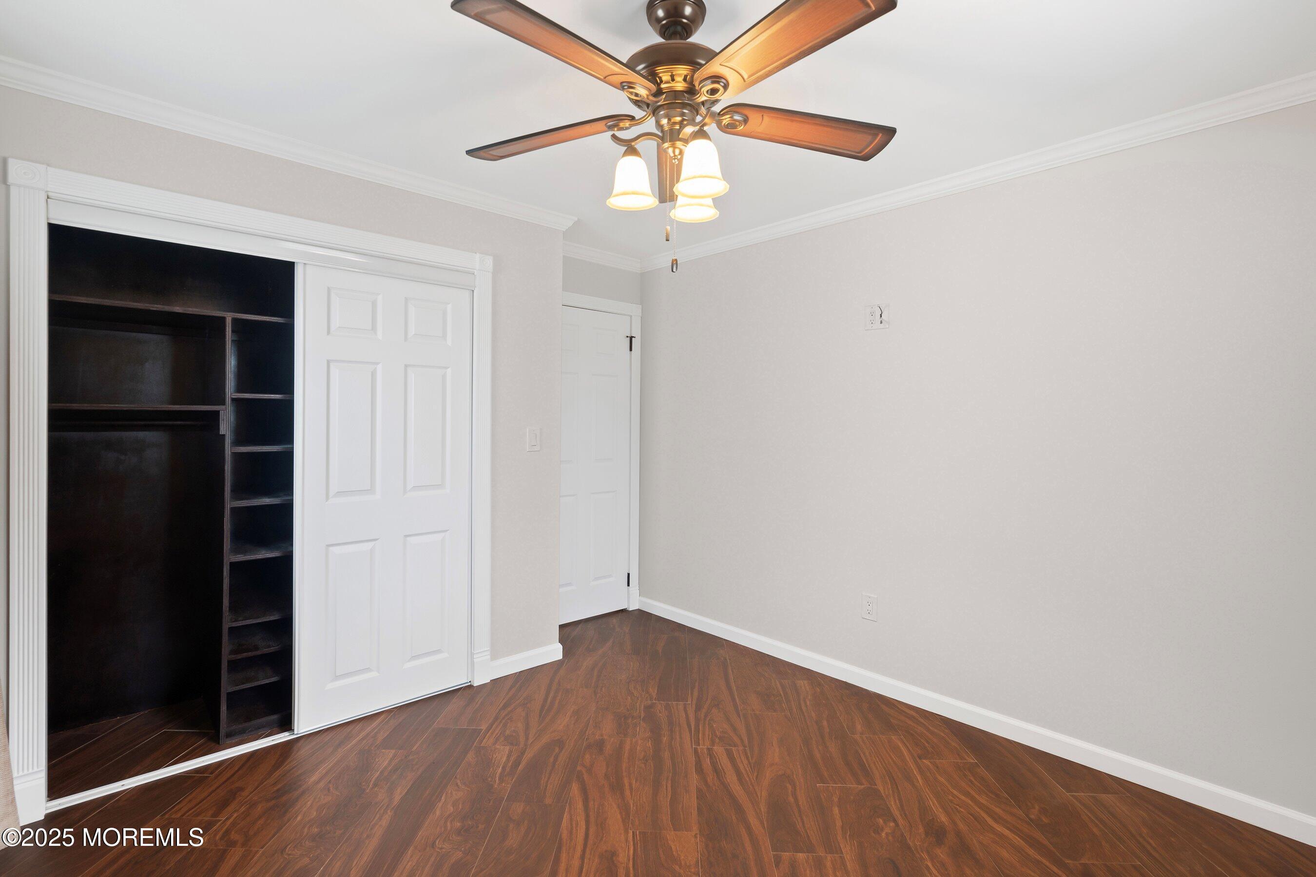 29 Pine Needle Street Howell, NJ 07731 - Photo 16 of 26 an empty room with a ceiling fan and wooden floor