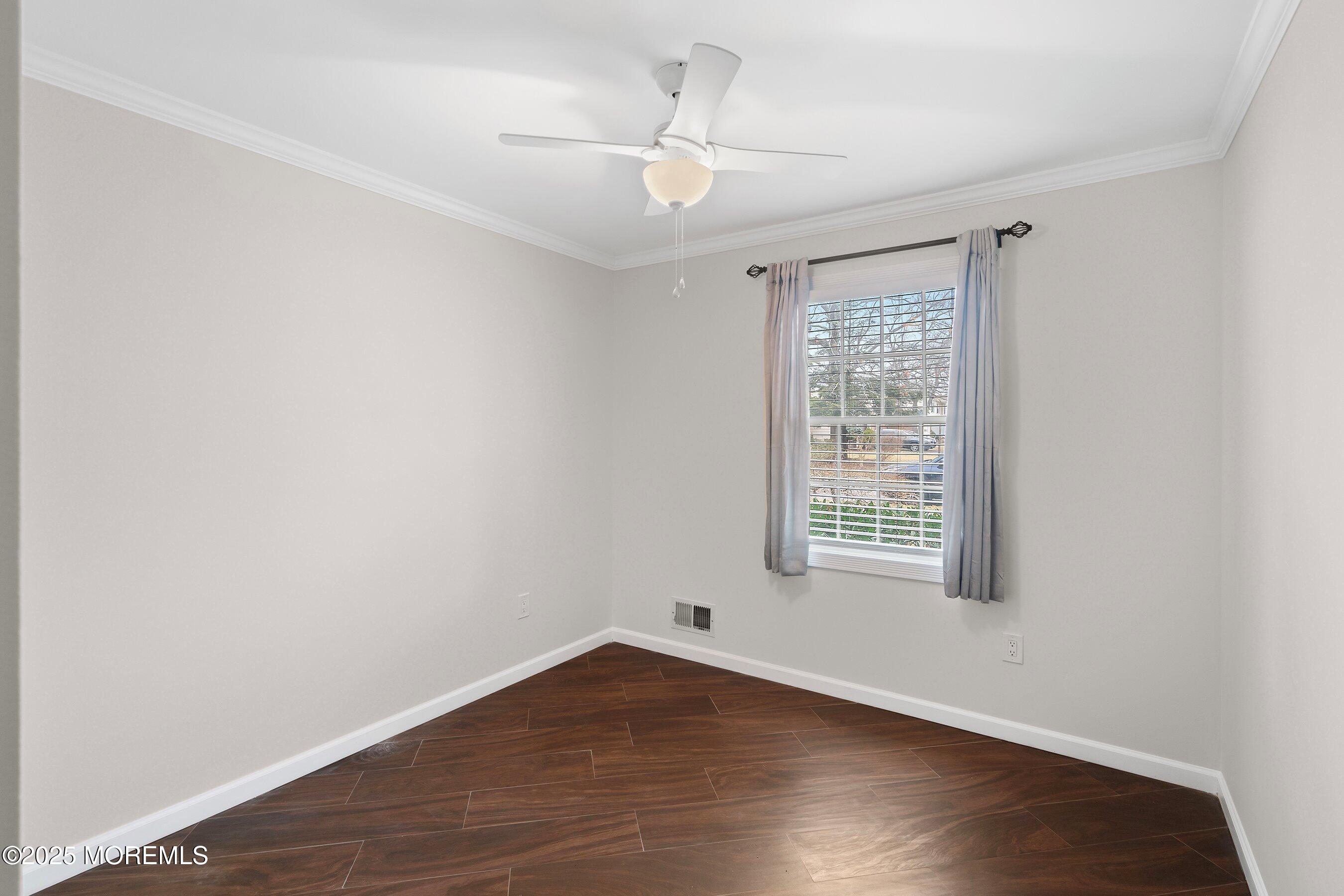 29 Pine Needle Street Howell, NJ 07731 - Photo 18 of 26 a view of an empty room with wooden floor and a window