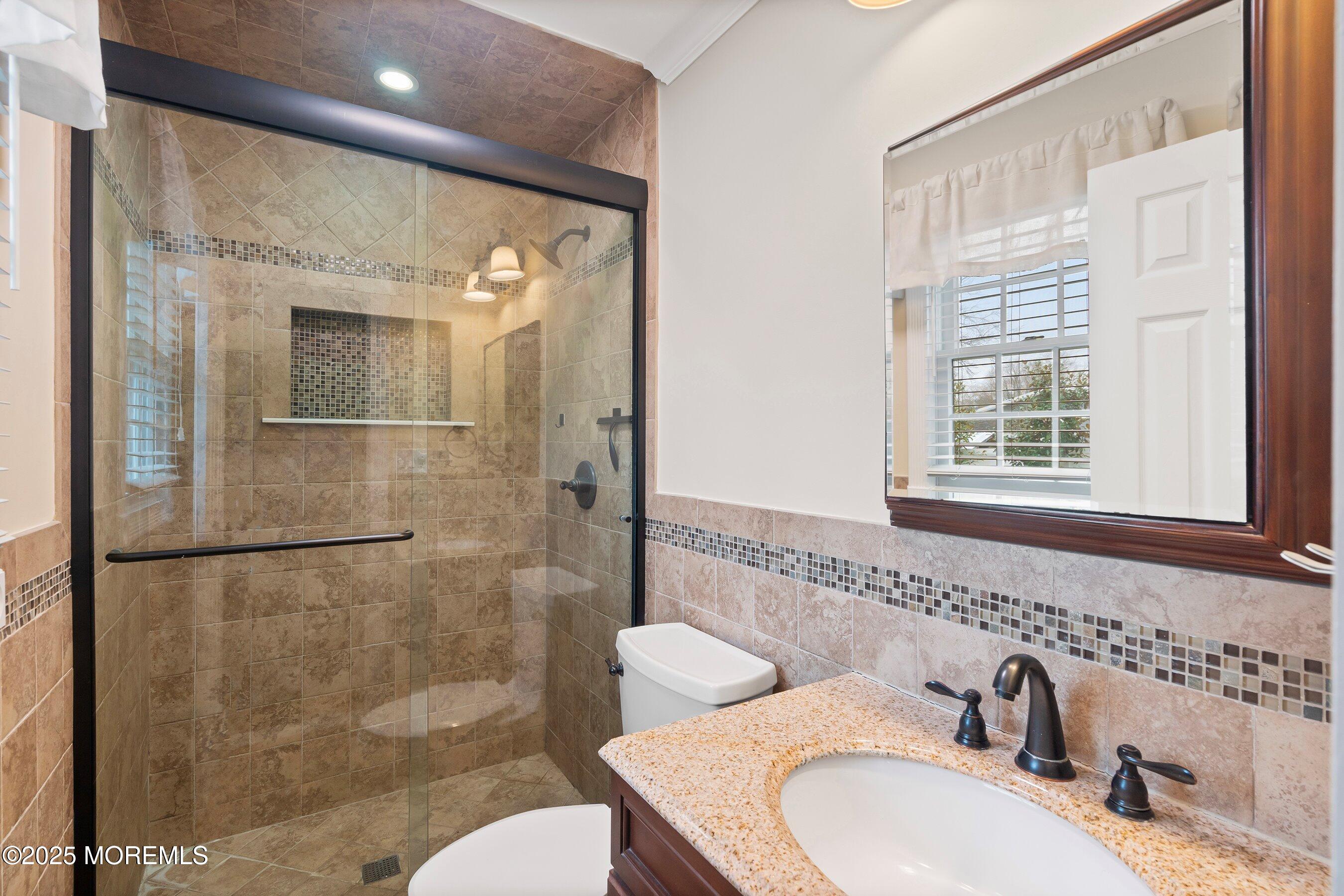 29 Pine Needle Street Howell, NJ 07731 - Photo 21 of 26 a bathroom with a sink toilet and shower