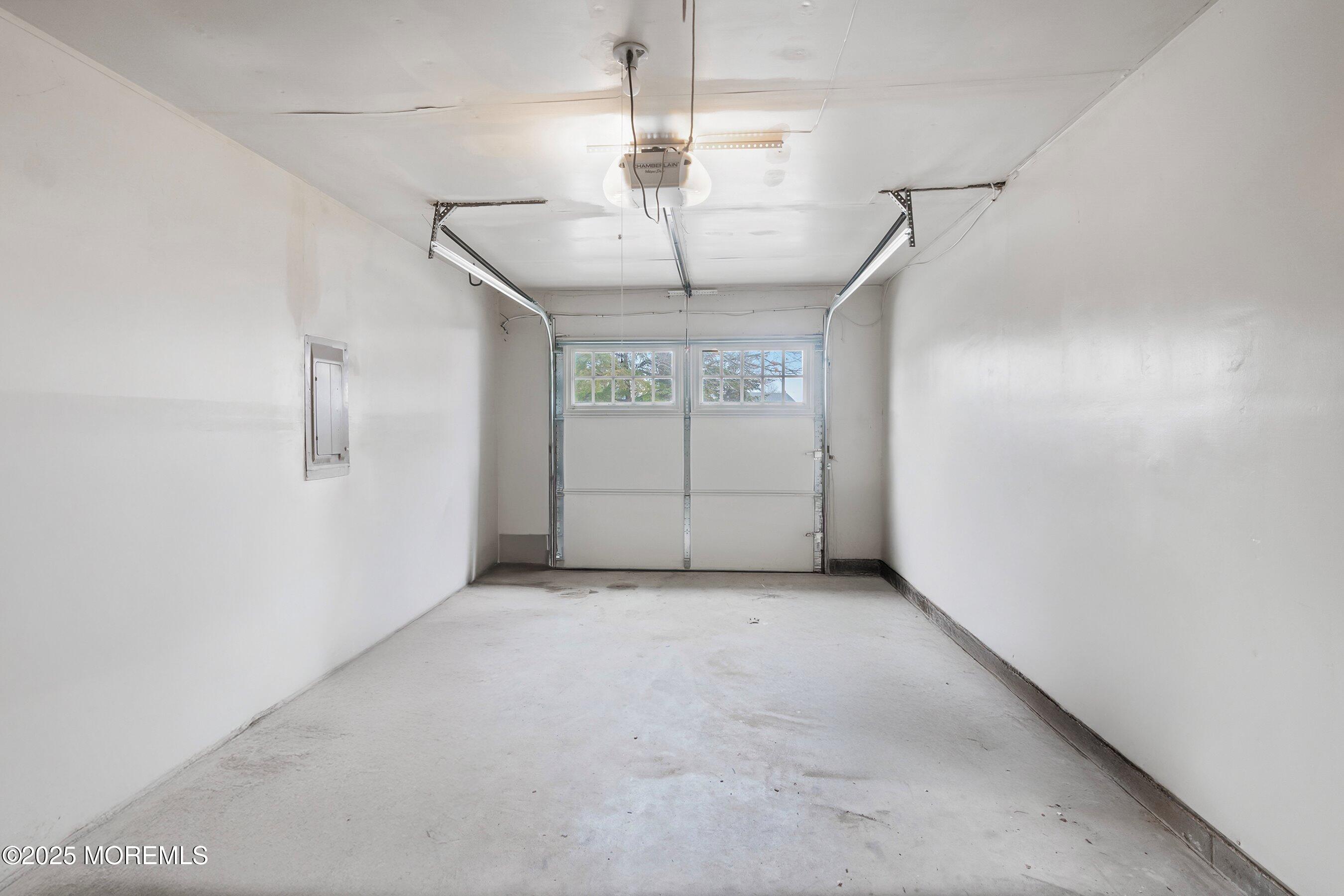 29 Pine Needle Street Howell, NJ 07731 - Photo 22 of 26 an empty room with chandelier and windows