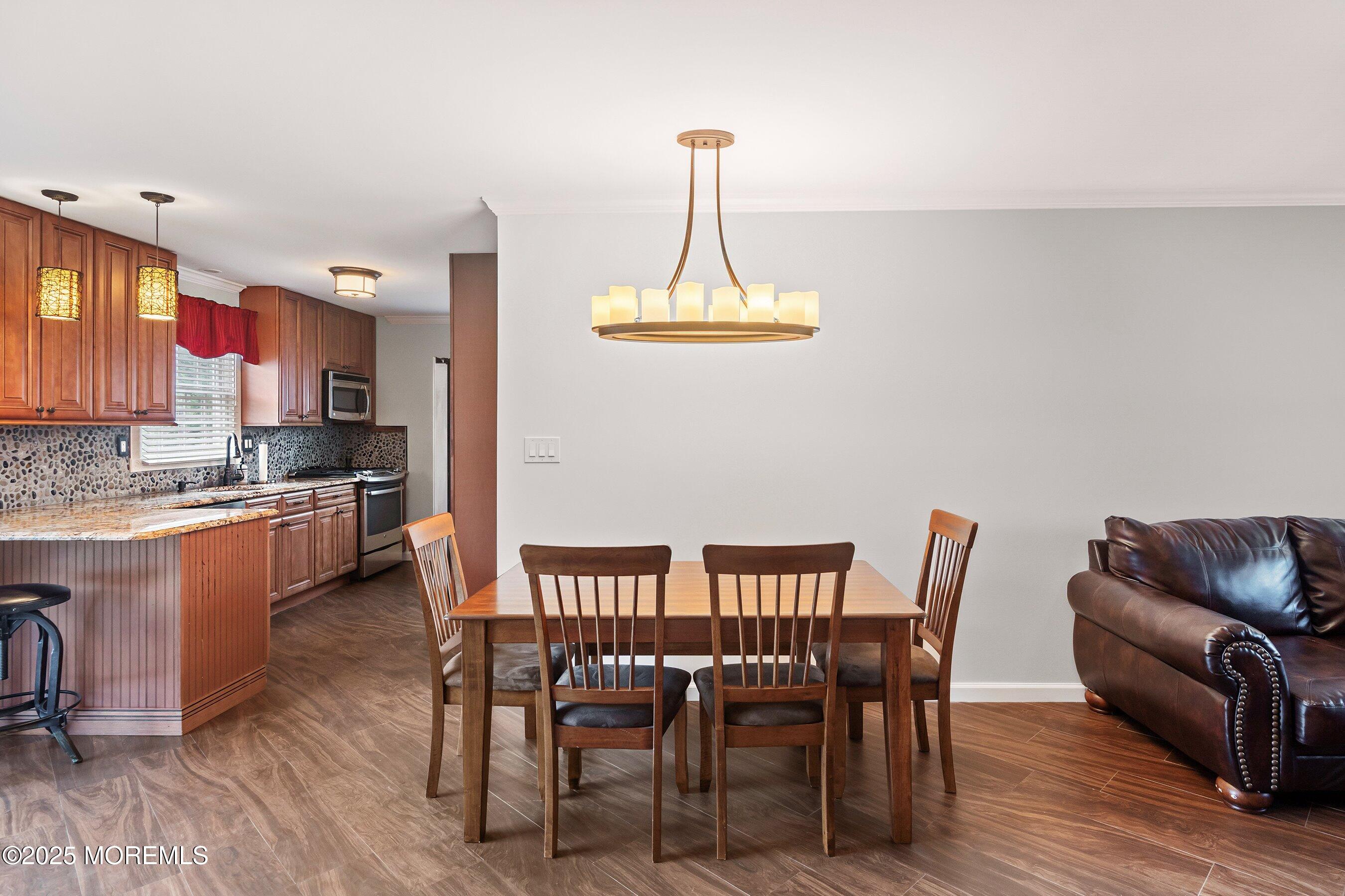 29 Pine Needle Street Howell, NJ 07731 - Photo 6 of 26 a view of a dining room with furniture window and wooden floor
