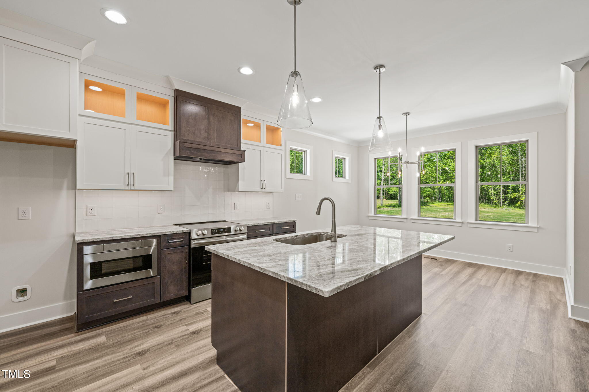 310 Pilot Ridge Road Zebulon, NC 27597 - Photo 11 of 46 a kitchen with stainless steel appliances granite countertop a sink a stove and a wooden floors