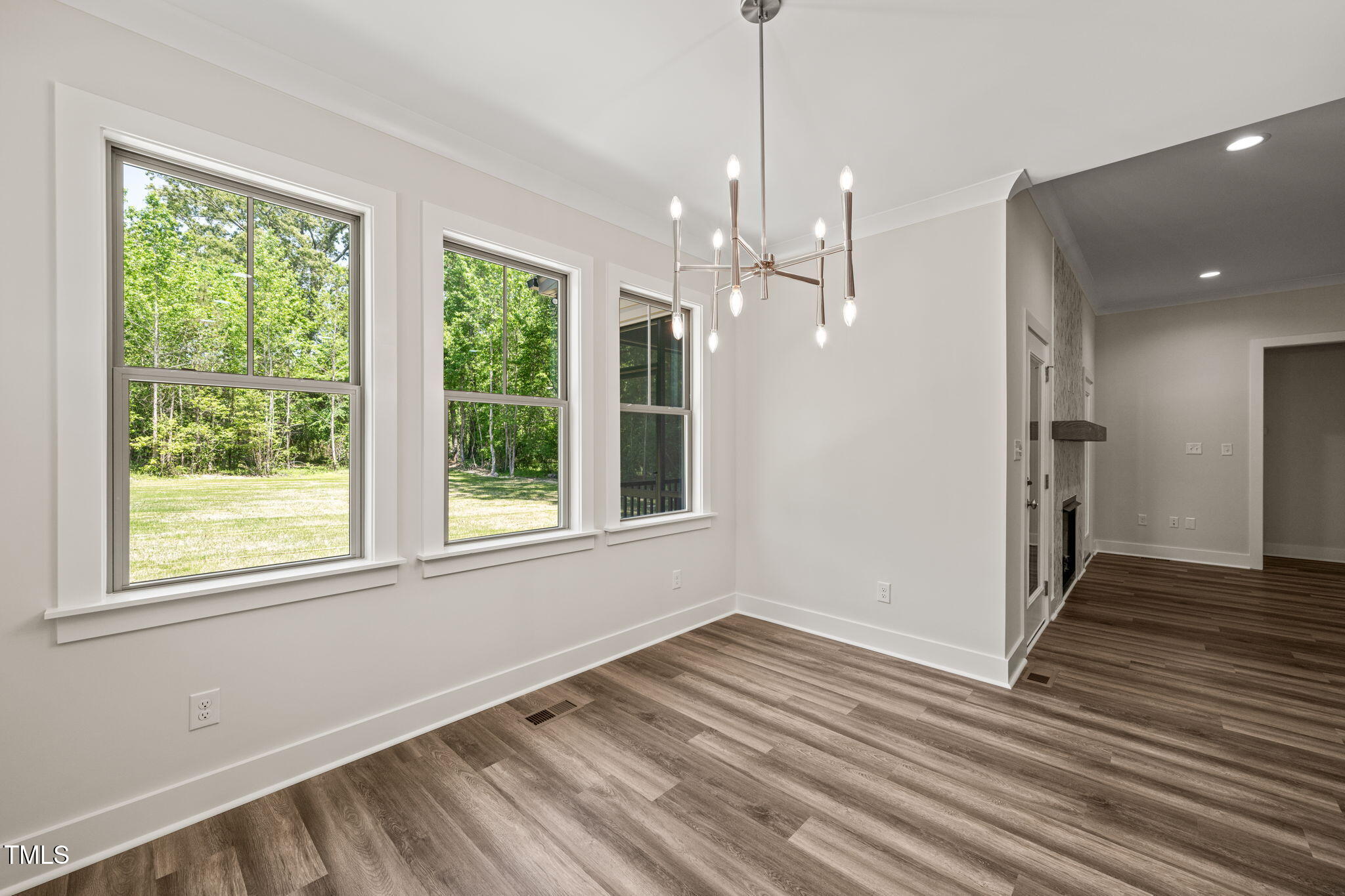 310 Pilot Ridge Road Zebulon, NC 27597 - Photo 14 of 46 a view of empty room with wooden floor and windows