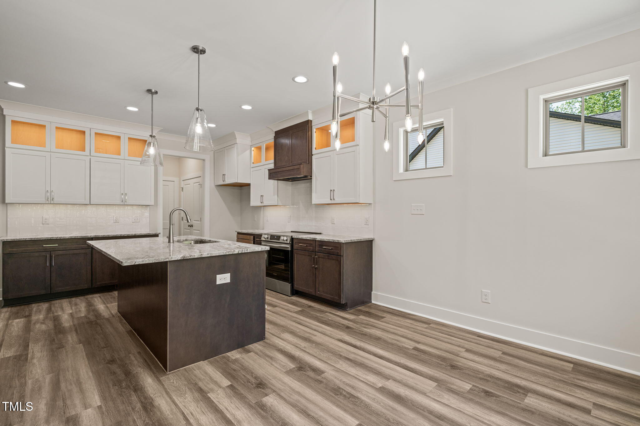 310 Pilot Ridge Road Zebulon, NC 27597 - Photo 15 of 46 a large kitchen with stainless steel appliances a large counter top a sink a stove and a refrigerator