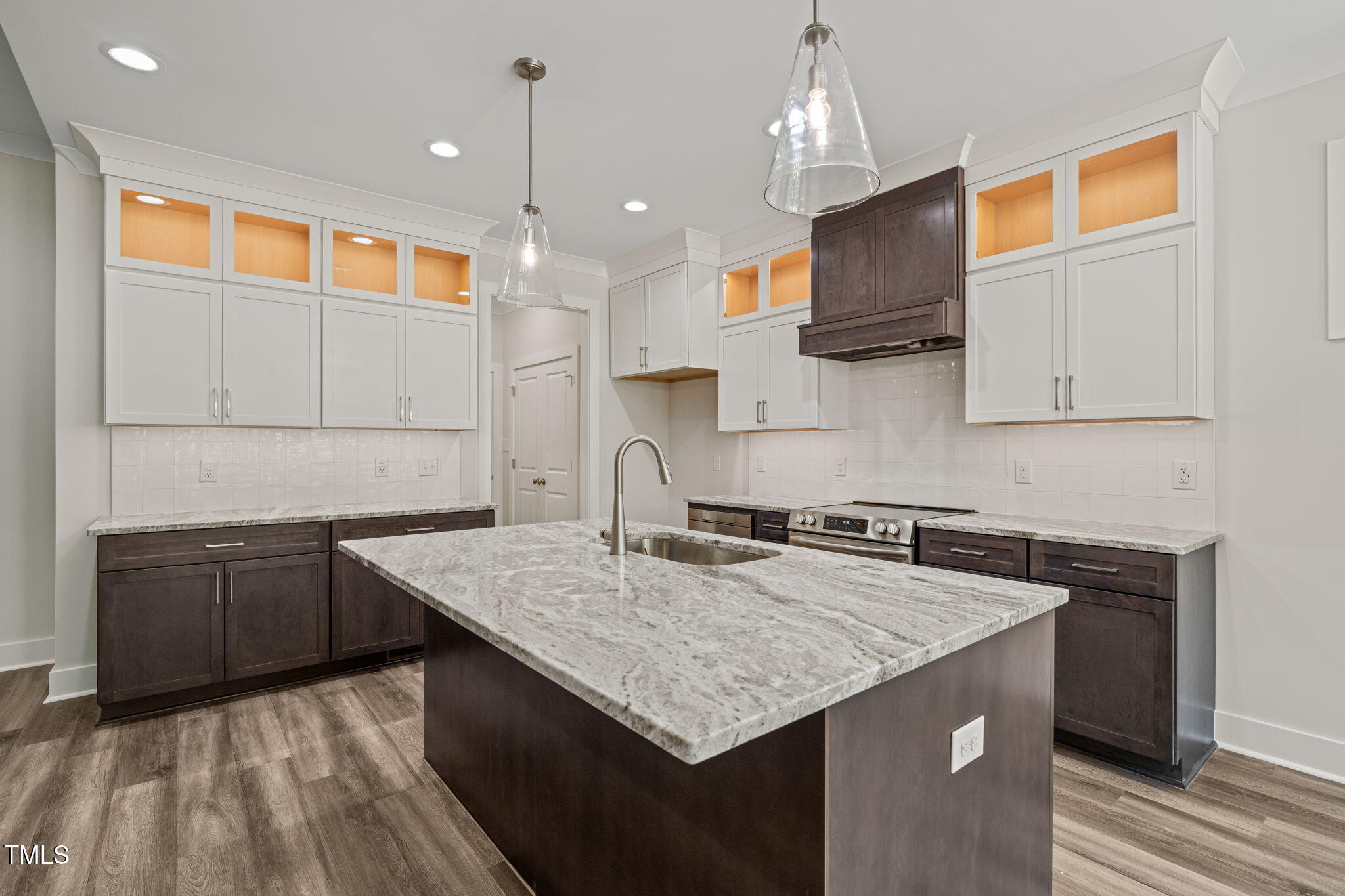 310 Pilot Ridge Road Zebulon, NC 27597 - Photo 16 of 46 a kitchen with granite countertop kitchen island stainless steel appliances a sink stove top oven and cabinets