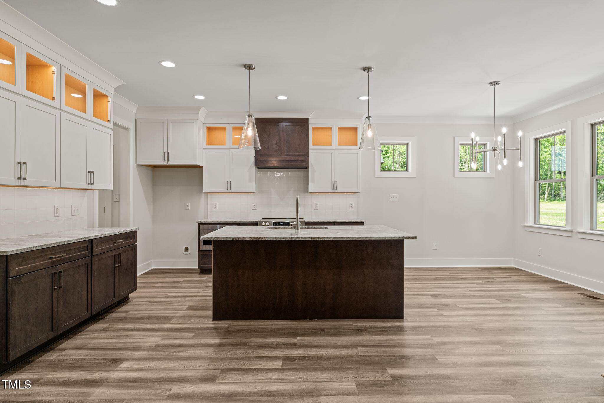 310 Pilot Ridge Road Zebulon, NC 27597 - Photo 18 of 46 a kitchen with stainless steel appliances granite countertop a stove a sink and a wooden floors