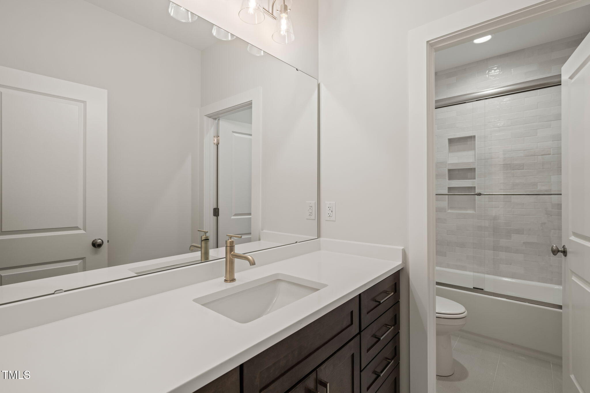310 Pilot Ridge Road Zebulon, NC 27597 - Photo 30 of 46 a bathroom with a sink a toilet and shower