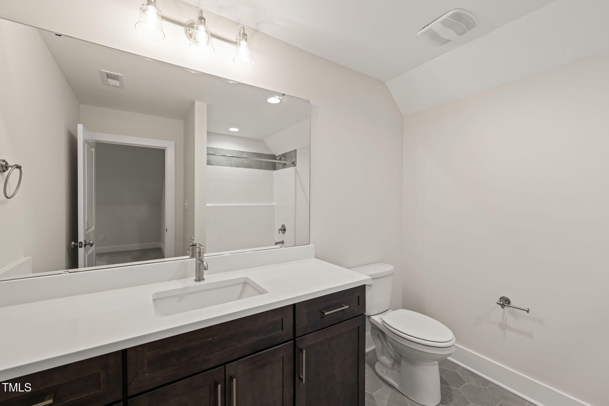310 Pilot Ridge Road Zebulon, NC 27597 - Photo 36 of 46 a bathroom with a sink a toilet a mirror and vanity