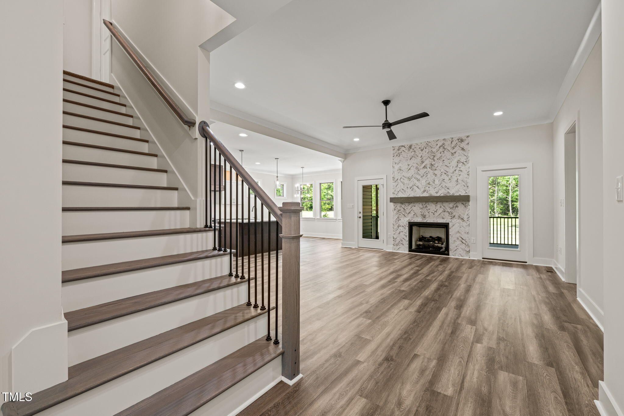 310 Pilot Ridge Road Zebulon, NC 27597 - Photo 5 of 46 a view of a livingroom with wooden floor staircase and a ceiling fan