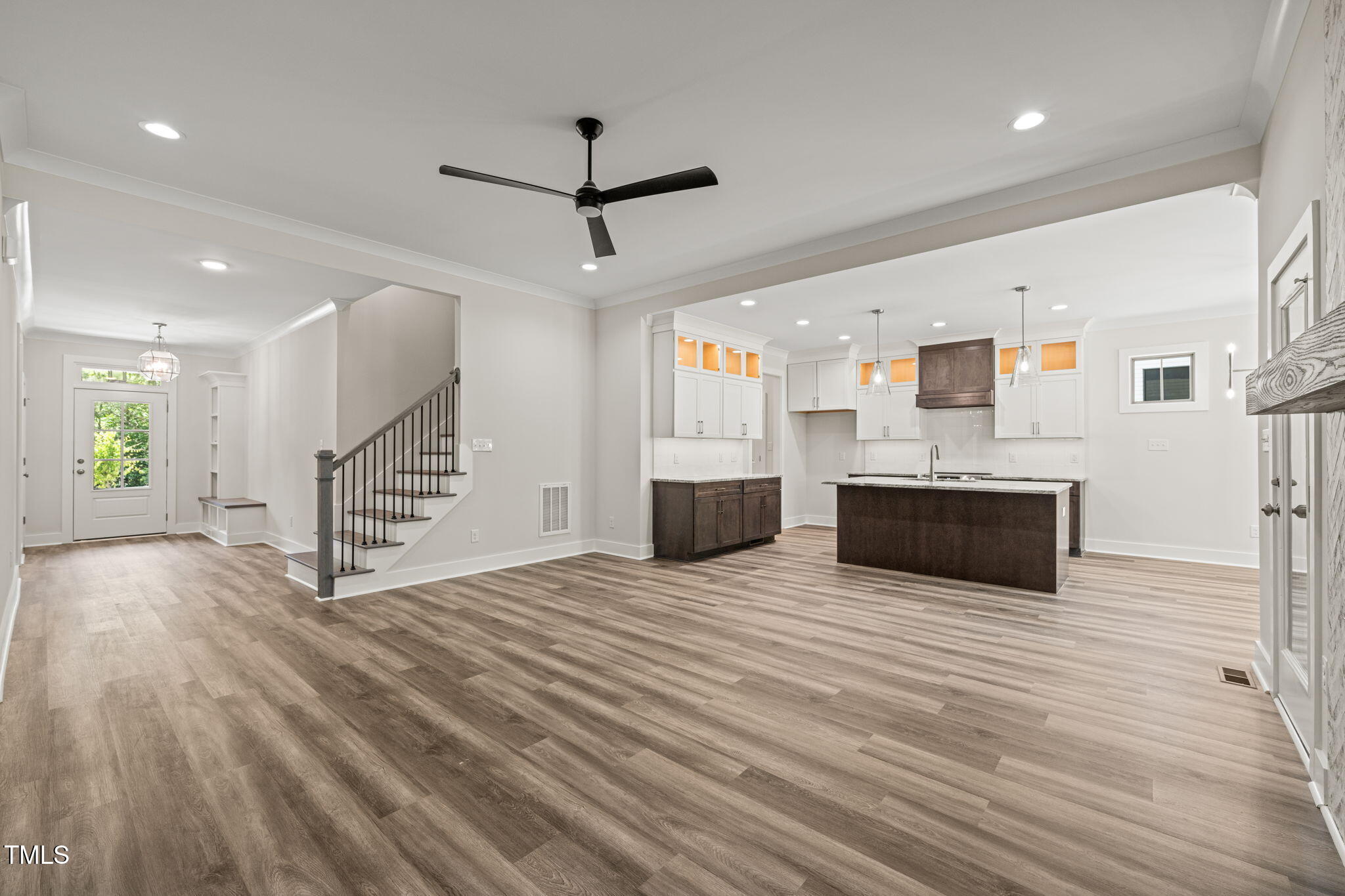 310 Pilot Ridge Road Zebulon, NC 27597 - Photo 8 of 46 a large white kitchen with wooden floors and a fireplace