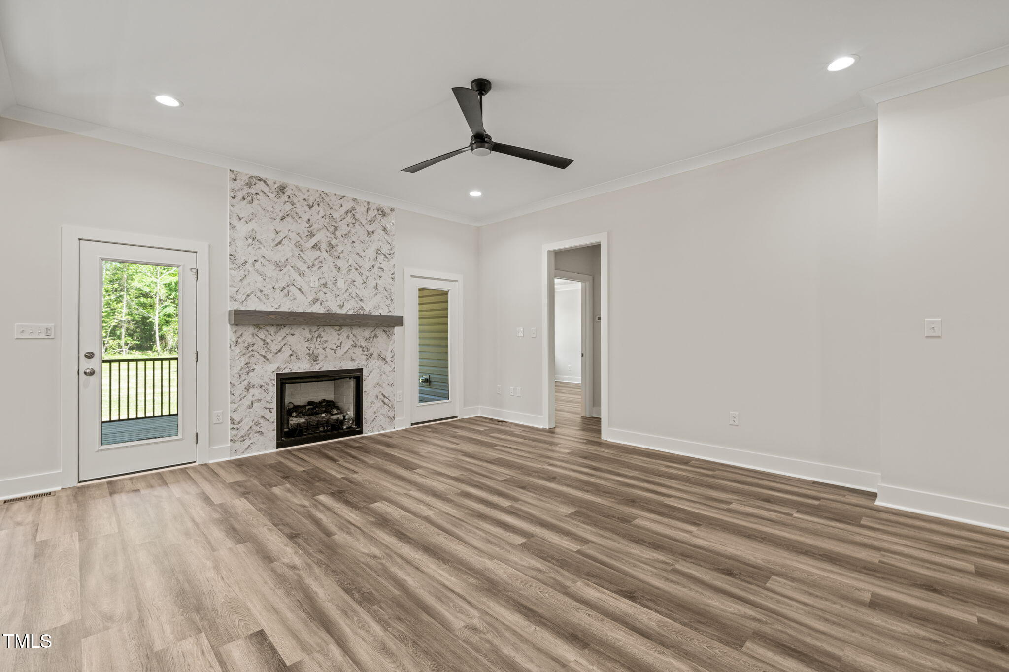 310 Pilot Ridge Road Zebulon, NC 27597 - Photo 10 of 46 a view of empty room with wooden floor fireplace and window