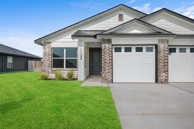 a front view of a house with a yard and porch