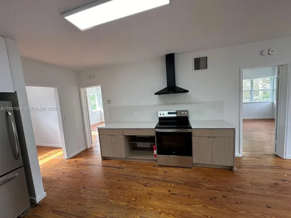 a kitchen with a stove and a refrigerator