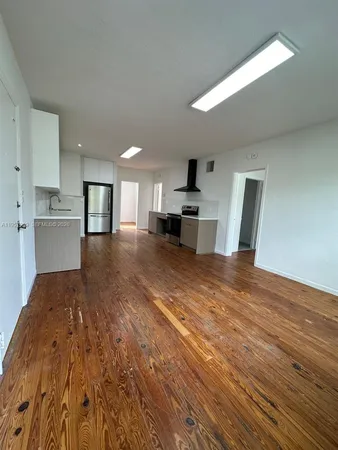 a large room with kitchen view