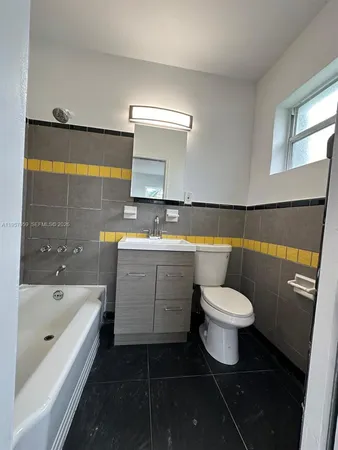 a bathroom with a sink toilet a bathtub and shower