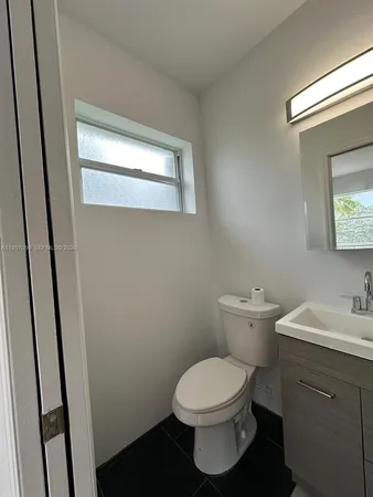 a white toilet sitting next to a bathroom sink