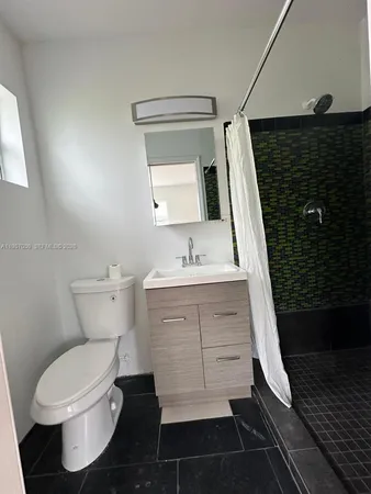 a bathroom with a sink toilet and mirror