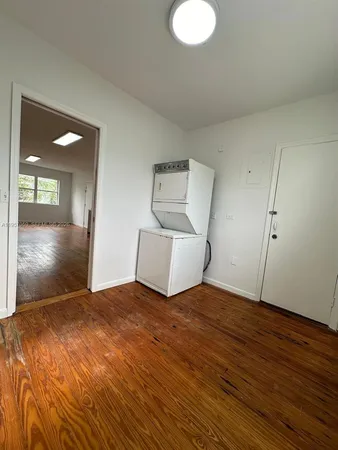 a view of a bedroom with wooden floor