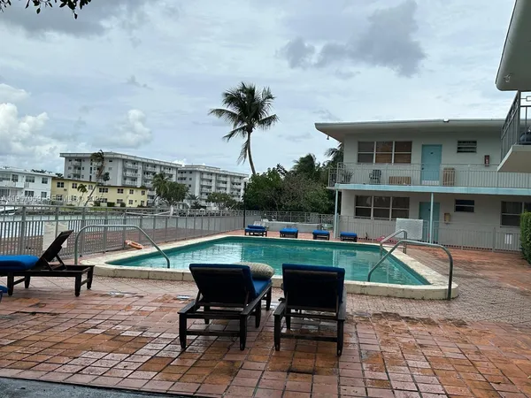 a view of a swimming pool with outdoor seating