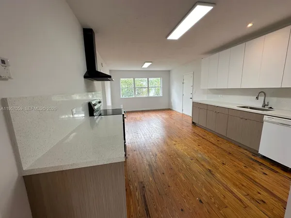 a kitchen with a sink a window and stainless steel appliances