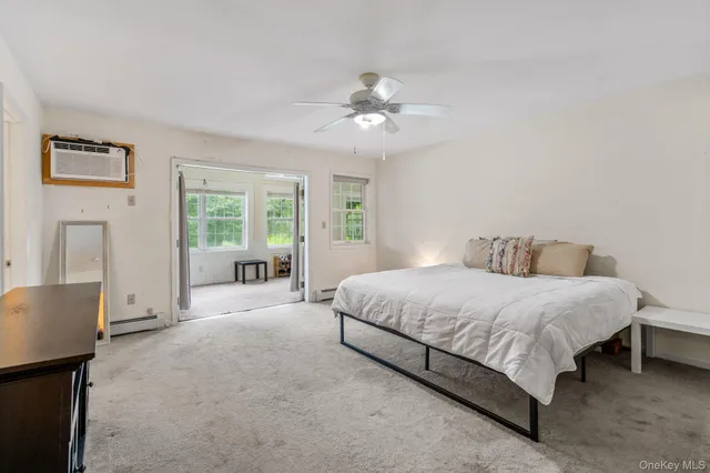 a spacious bedroom with a large bed and a chandelier