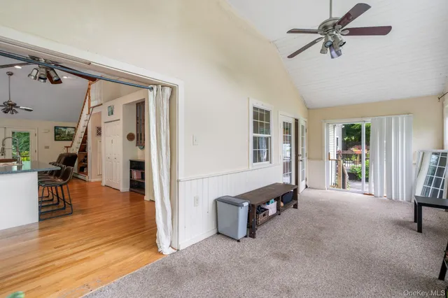 a view of a livingroom with furniture and hardwood floor