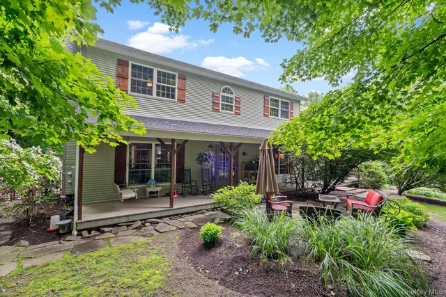 a view of a chairs and table in a backyard