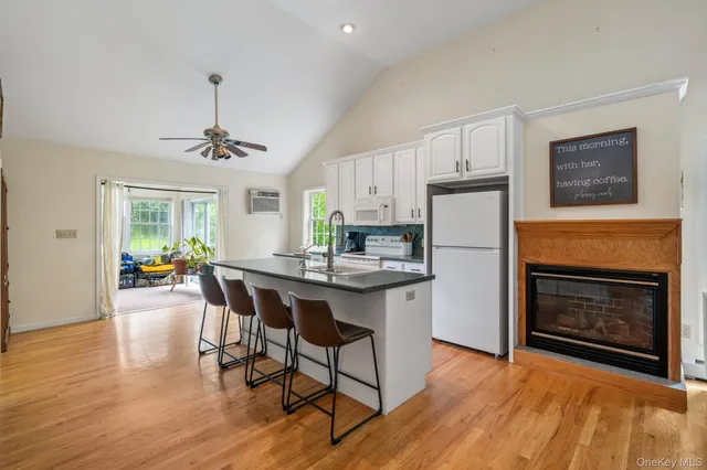 a kitchen with stainless steel appliances a stove a sink a refrigerator a center island and furniture