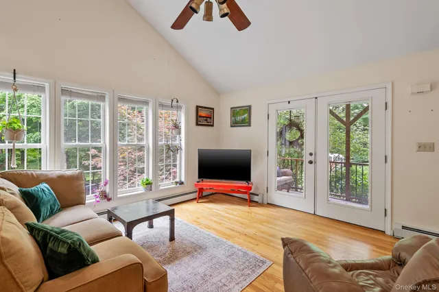 a kitchen with stainless steel appliances a dining table chairs stove refrigerator and cabinets