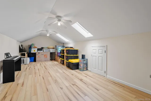 a living room with furniture ceiling fan and a flat screen tv