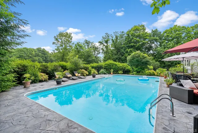 a view of a patio with couches under an umbrella