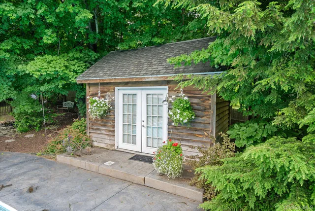 a view of a house with swimming pool and sitting area