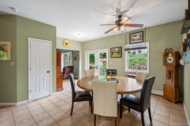 a view of a dining room with furniture and a chandelier