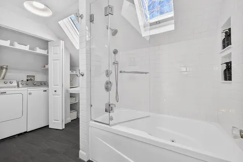 a bathroom with a bathtub and a shower