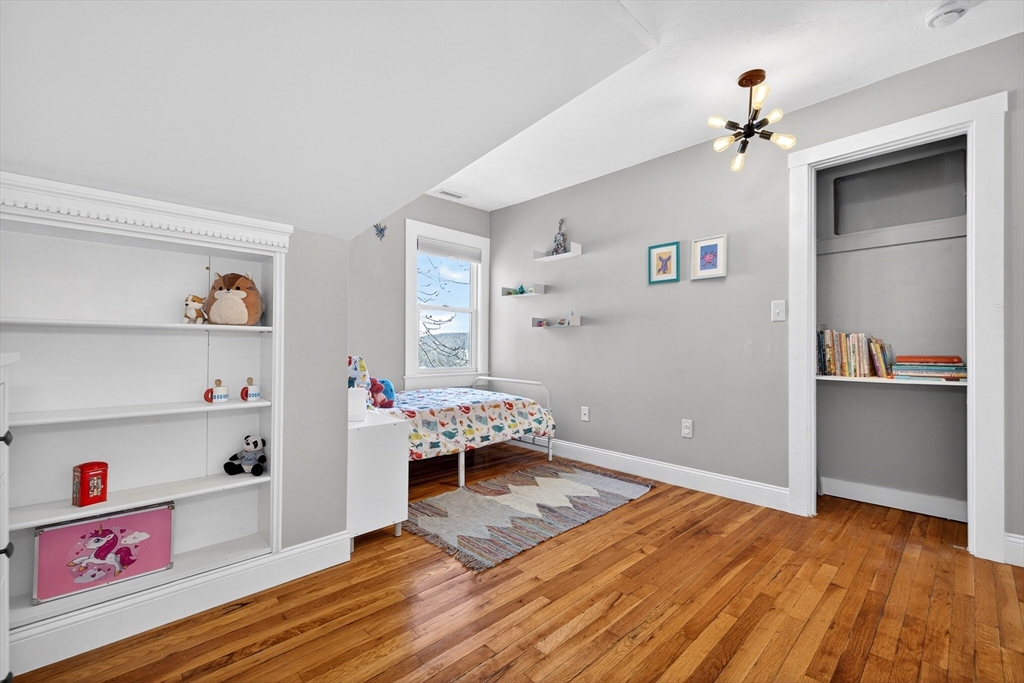 16 Primrose Street, Unit 3 Boston, MA 02131 - Photo 14 of 26 a living room with hard wood floors and a couch