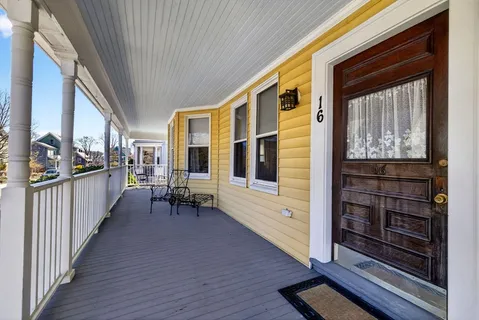 a view of a porch with wooden floor and furniture