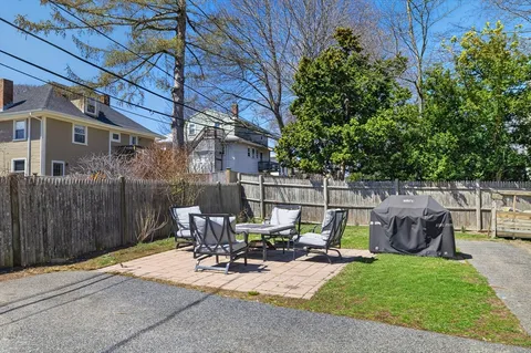 a view of backyard with patio and outdoor seating