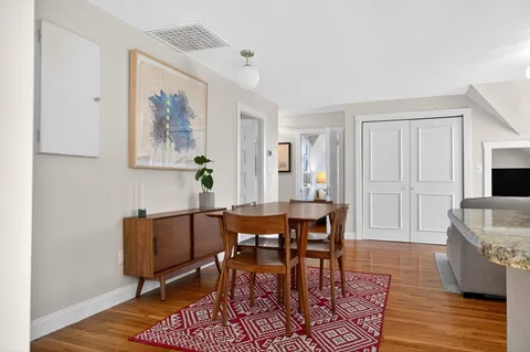 a dining room with furniture and wooden floor