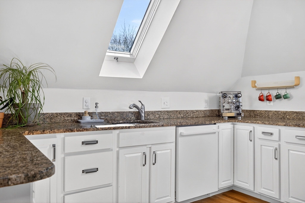 16 Primrose Street, Unit 3 Boston, MA 02131 - Photo 9 of 26 a kitchen with granite countertop a sink and cabinets